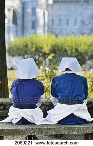 Stock Image - Nuns In Prayer Sanctuary Of Our Lady Of Lourdes; Lourdes Hautes-Pyrenees France. Fotosearch