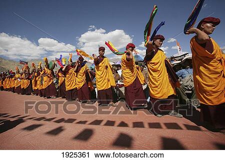 Nuns / Monks In Traditional Dress With Yellow Orange Hats And Robes Dancing And Banging Drums At 800 Year Old Birthday Celebration / Rituals Of The Buddhist Drukpa Lineage, Naro Photang Shey, (Shey Monastery), Leh Ladakh, Indian Himalayas, India View Large Photo Image Stock Image - Nuns / Monks In Traditional Dress With Yellow Orange Hats And Robes Dancing And Banging Drums At 800 Year Old Birthday Celebration / Rituals Of The Buddhist Drukpa Lineage, Naro Photang Shey, (Shey Monastery), Leh Ladakh, Indian Himalayas, India. Fotosearch