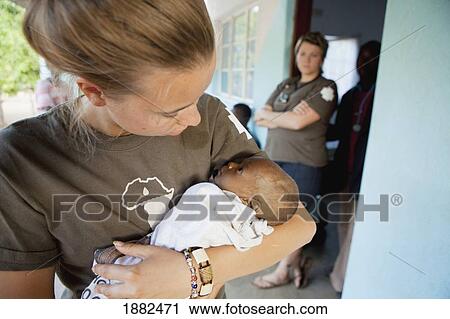 Nurse Comforting An Infant Dying Of Hiv Aids Manica Mozambique