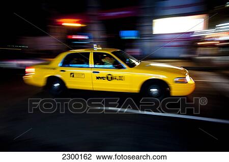 Stock Image - Ny Taxi At Night In Manhattan, New York, Usa. Fotosearch