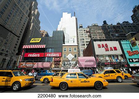 Stock Image - Ny Taxis In A Commercial Area In Manhattan, New York, Usa. Fotosearch
