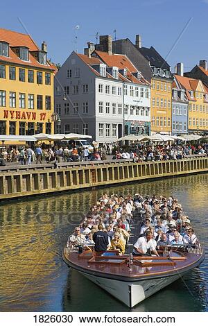 Stock Image - Nyhavn Canal, Copenhagen, Denmark; Tour Boat On A Canal. Fotosearch