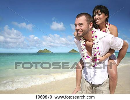 Stock Photo - Oahu, Hawaii, Lanikai, Young Couple Both Holding Eachother.. Fotosearch