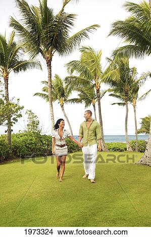 Picture - Oahu, Hawaii, Young Couple Both Holding Eachother.. Fotosearch
