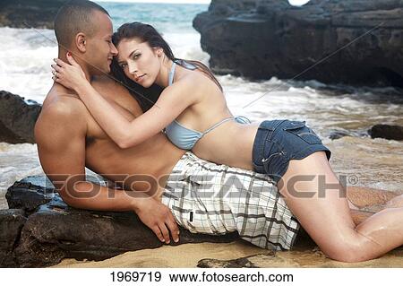 Stock Photo - Oahu, Hawaii, Young Couple Both Holding Each Other.. Fotosearch