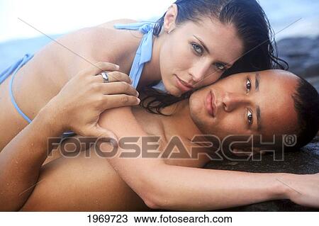 Oahu, Hawaii, Young Couple Laying On Sand. View Large Photo Image Stock Image - Oahu, Hawaii, Young Couple Laying On Sand.. Fotosearch