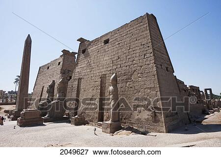 Stock Photo - Obelisk And Granite Colossi Of Ramses Ii In Front Of The Entrance Pylon Of The Luxor Temple, Luxor, Qina, Egypt. Fotosearch