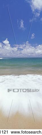 Stock Image - Ocean Shore Break Action Upon Shoreline, Turquoise Water And Blue Sky With Clouds Panoramic. Fotosearch