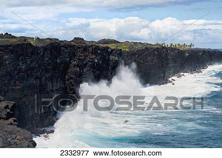 Ocean splashes against lava rock cliff, Hawaii Volcanoes National Park; Big Island, Hawaii, United States of America View Large Photo Image Stock Photo - Ocean splashes against lava rock cliff, Hawaii Volcanoes National Park; Big Island, Hawaii, United States of America. Fotosearch