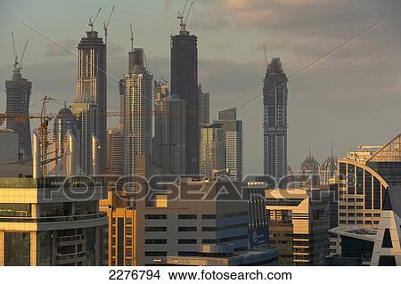 Picture - Office and residential tower blocks at dusk; Dubai, United Arab Emirates. Fotosearch