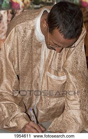 Stock Image - Official at the Tourism Office, Timbuktu, Mali. Fotosearch