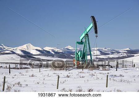 Stock Photo - Oil Industry Pumpjack In Winter; Longview, Alberta, Canada. Fotosearch