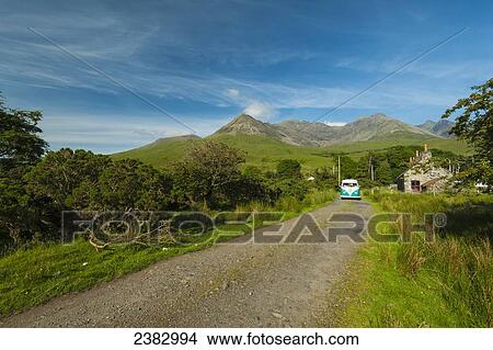 Old 1960's VW van coming down the road with the hills of the Black Cuillin behind; Glen Brittle, Isle of Skye, Scotland View Large Photo Image Picture - Old 1960's VW van coming down the road with the hills of the Black Cuillin behind; Glen Brittle, Isle of Skye, Scotland. Fotosearch