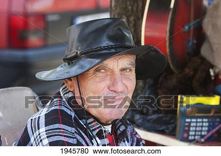 Stock Image - Old Bulgarian man at the flea market, Sofia, Bulgaria. Fotosearch