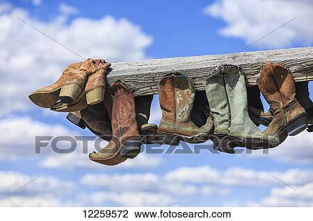 Old cowboy boots hanging in memory of John Booth, Great Sandhills, near Sceptre; Saskatchewan, Canada View Large Photo Image Stock Image - Old cowboy boots hanging in memory of John Booth, Great Sandhills, near Sceptre; Saskatchewan, Canada. Fotosearch