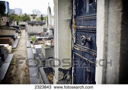 Stock Image - Old crypt door at Montmartre cemetery; Paris, France. Fotosearch
