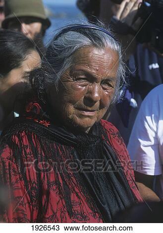 Stock Image - Old Gypsy Lady At Annual Festival When Cowboys Of The Camargue Escort Statue Of Ste-Sarah Down To The Sea In Town Of Les Stes-Maries-De-La-Mer. Fotosearch