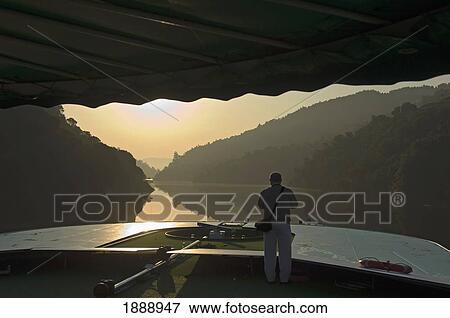 Stock Photo - Old Man Enjoying Sunrise On Douro Valley River Cruise. Fotosearch