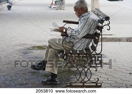 Old Man Reading A Newspaper On A Bench, Cairo, Al Qahirah, Egypt View Large Photo Image Stock Image - Old Man Reading A Newspaper On A Bench, Cairo, Al Qahirah, Egypt. Fotosearch