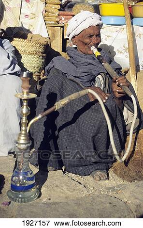 Stock Photo - Old Man Smoking Hookah; Aswan, Upper Egypt, Egypt. Fotosearch