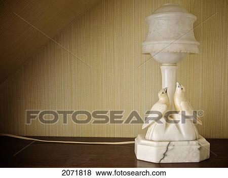 Stock Photo - Old Marble Lamp With Two Birds Against Striped Wallpaper. Fotosearch