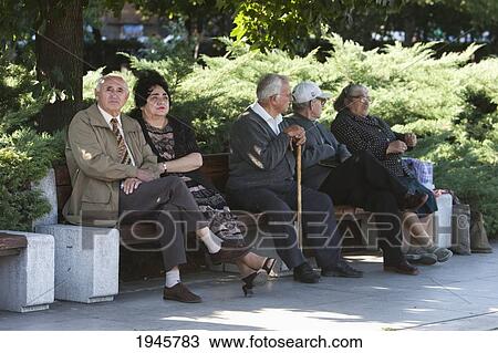 Stock Image - Old people on a bench in Yuzhen Park, Sofia, Bulgaria. Fotosearch