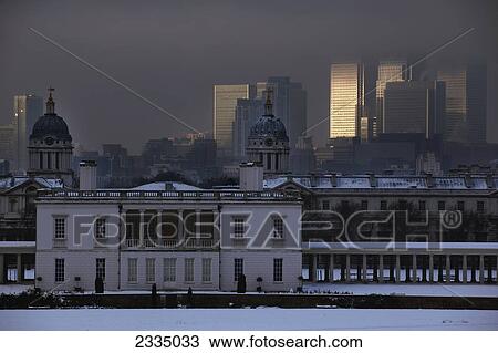 Stock Image - Old Royal Naval College And Canary Wharf In Snow; London, England, Uk. Fotosearch