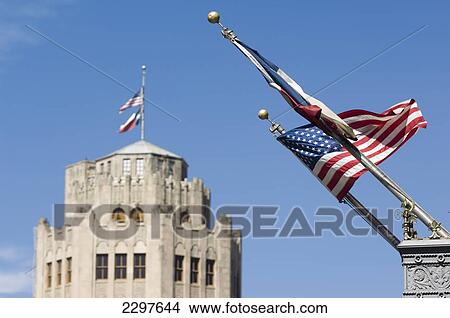 Picture - Old San Antonio News Building In Background With Stars And Stripes (Us Flag) And Lone Star (Texas Flag) In Foreground, San Antonio, Texas, Usa. Fotosearch