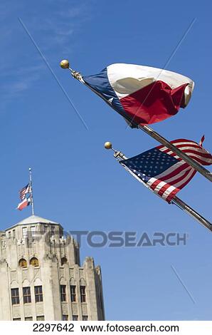 Stock Image - Old San Antonio News Building In Background With Stars And Stripes (Us Flag) And Lone Star (Texas Flag) In Foreground, San Antonio, Texas, Usa. Fotosearch
