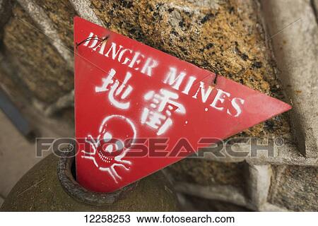 Stock Image - Old sign of danger mines from the civil war; Kinmen, Taiwanese. Fotosearch