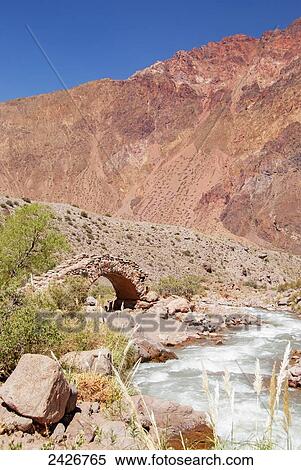 Stock Photography - Old stone footbridge in colourful mountains; Mendoza, Argentina. Fotosearch