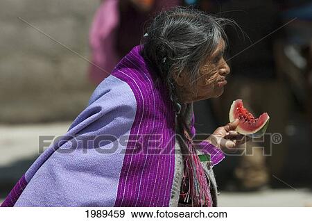 Stock Photo - Old Tzotzil Maya Woman Eating A Piece Of Watermelon, Zinacantan, Chiapas, Mexico. Fotosearch