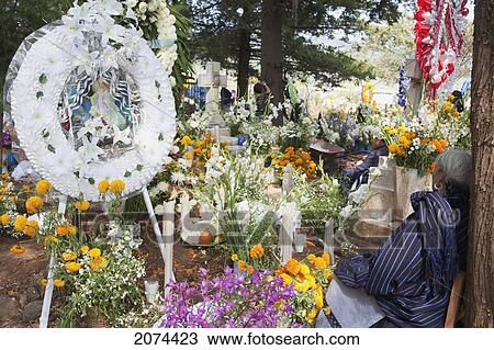 Stock Image - Old Woman By A Grave During The Celebration Of D. Fotosearch