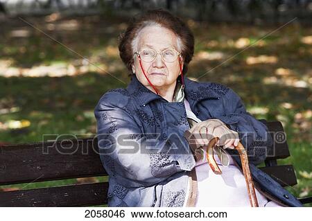 Old Woman Sitting On A Park Bench, Budapest, Hungary View Large Photo Image Stock Photograph - Old Woman Sitting On A Park Bench, Budapest, Hungary. Fotosearch