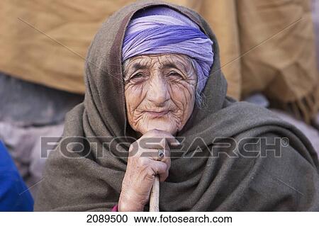 Stock Image - Old Woman Waiting For Aid And Relief Goods Near The Line Of Control, Chakothi, Azad Kashmir, Pakistan. Fotosearch