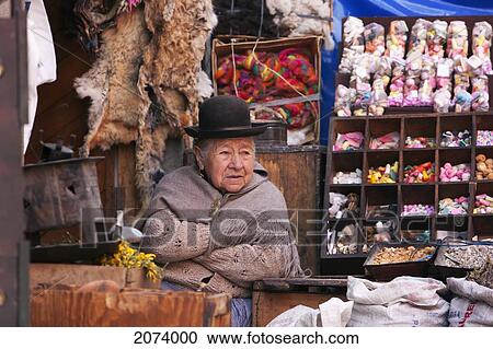 Stock Image - Ole Aymara Woman And Her Dog At The Mercado De Las Brujas (Witches' Market) On Calle Linares In La Paz., La Paz Department, Bolivia. Fotosearch