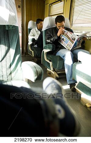Onboard The Train From Tunis To Hammamet. Passanger Reading Newspaper. Tunisia, North Africa. View Large Photo Image Stock Image - Onboard The Train From Tunis To Hammamet. Passanger Reading Newspaper. Tunisia, North Africa.. Fotosearch