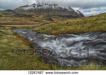 Stock Photo - One of the numerous streams coming from the mountains in the West Fjords region of Iceland; Iceland. Fotosearch