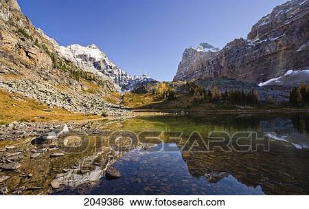 Stock Photograph - Opabin Plateau, Opabin Lake, Hungabee Mountain And Mount Biddle, Yoho National Park, British Columbia. Fotosearch