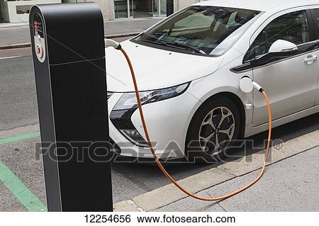 Stock Photograph - Opel Ampera electric car being recharged on street; Llubljana, Slovenia. Fotosearch
