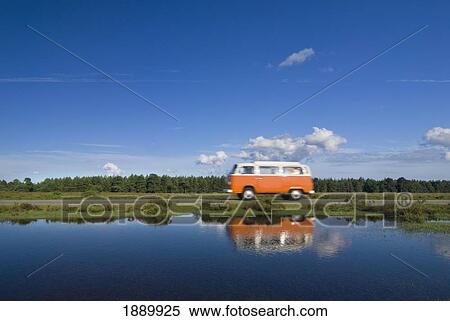Stock Photography - Orange Campervan Driving Past Pond. Fotosearch