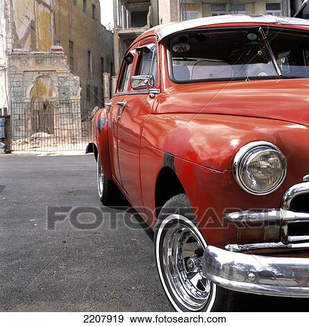 Stock Photo - Orange Car Front, Havana, Cuba.. Fotosearch