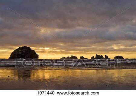 Oregon, Bandon Beach, Sunset Over Face Rock And Ocean. View Large Photo Image Stock Image - Oregon, Bandon Beach, Sunset Over Face Rock And Ocean.. Fotosearch