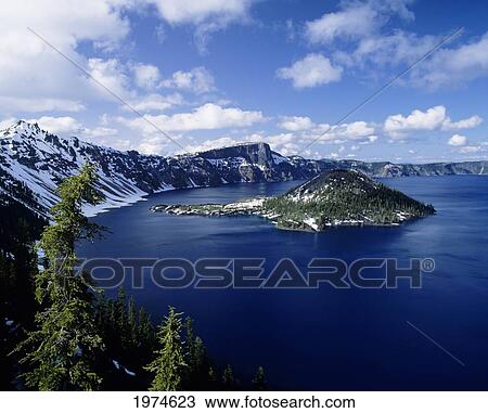 Stock Image - Oregon, Crater Lake National Park, Snowy Crater Lake And Wizard Island.. Fotosearch
