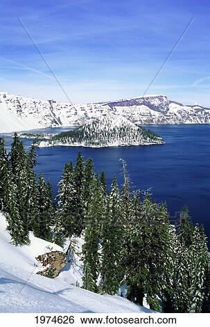 Stock Photograph - Oregon, Crater Lake National Park, Snowy Crater Lake And Wizard Island.. Fotosearch
