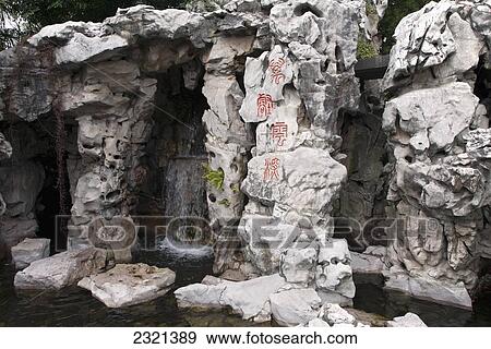 Stock Photo - Oregon, Portland, Chinese Gardens, Waterfall And White Rock Formations With Chinese Symbols.. Fotosearch