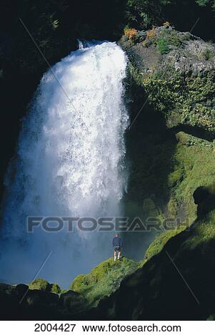 Stock Photo - Oregon, Sahalie Falls, View Of The Falls Man Walking In Foreground. Fotosearch
