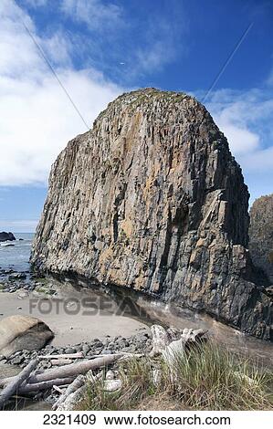 Stock Photo - Oregon, Southern Coast, Jessie M Honeyman Memorial State Park, Beach With Large Rock Formation In The Distance.. Fotosearch