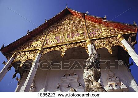 Stock Image - Ornate Gilded Wat, Low Angle View. Fotosearch