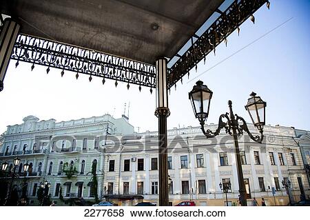 Stock Photo - Ornate lamp post and historic buildings in Odessa city centre; Odessa, Ukraine. Fotosearch